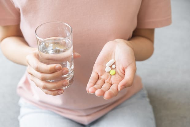 a person preparing to take several oral medications