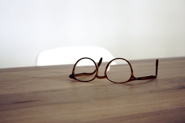 A pair of glasses on a wooden surface