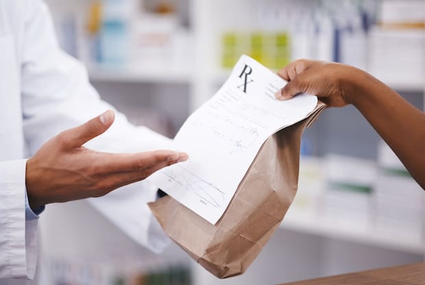 A patient picking up a prescription from the pharmacist&nbsp;