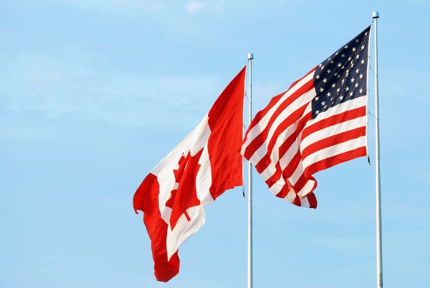 a Canadian flag next to a U.S. flag