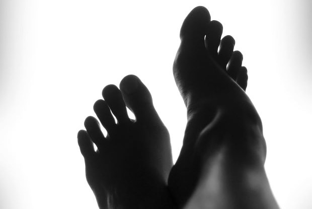 a black and white image of a person’s toes