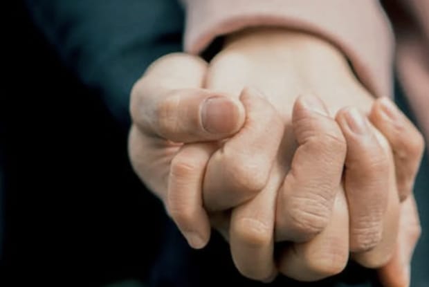 A close up of two hands holding