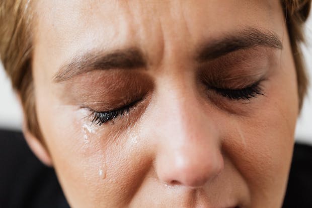 Tears running down a woman’s cheek