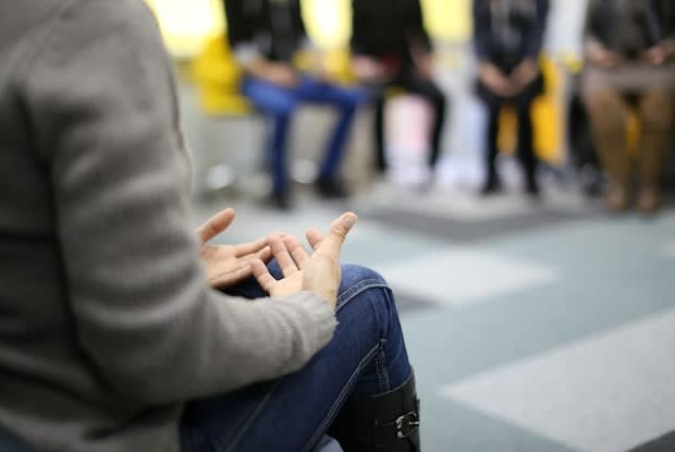 a person talking at a group therapy session