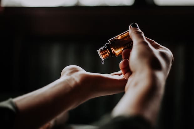 essential oil being applied to the palm of a hand