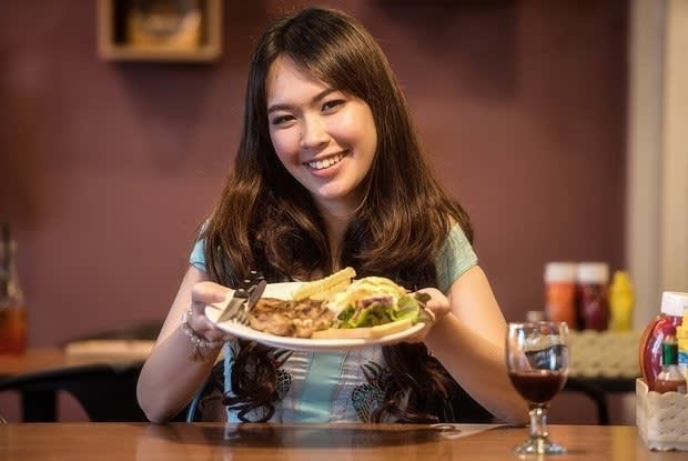 a person holding a plate of food