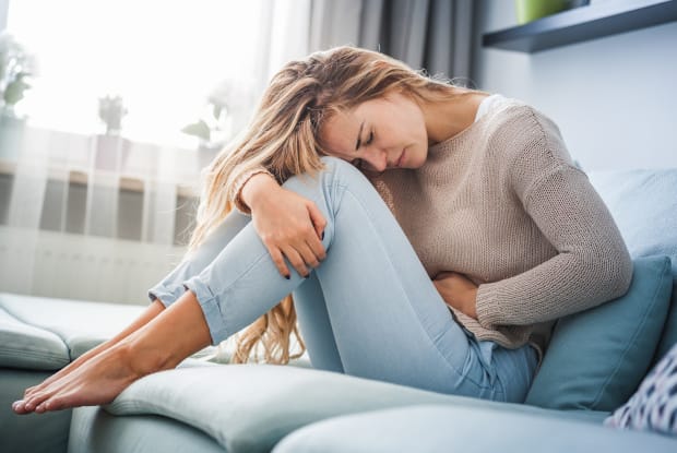 a woman experiencing stomach pain