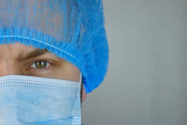 a doctor wearing a surgical cap and mask