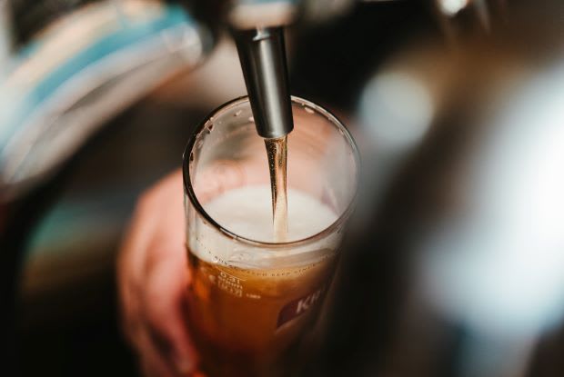 beer being poured into a glass