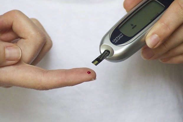 a person testing their blood sugar