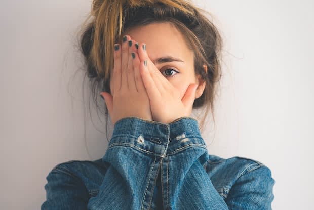 a woman covering her face