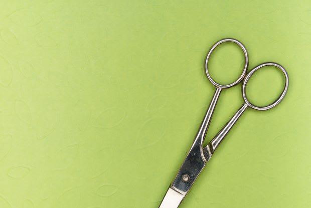 a pair of scissors on a green background