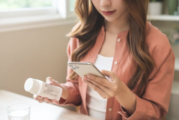 A woman ordering medication online through her phone
