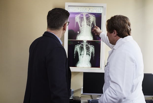 a doctor showing a patient an x-ray