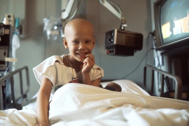 A young girl receiving chemotherapy in her hospital bed