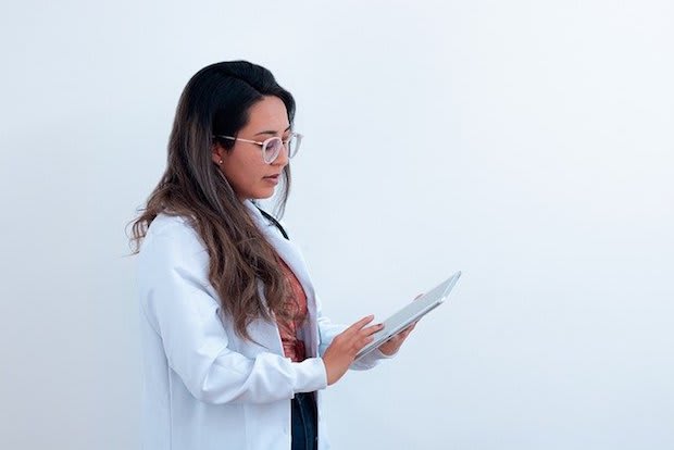 a doctor looking at an iPad