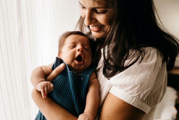 a woman holding a baby