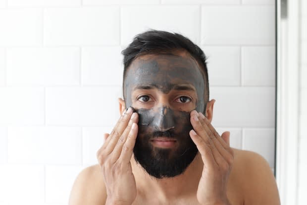 a man applying a face mask