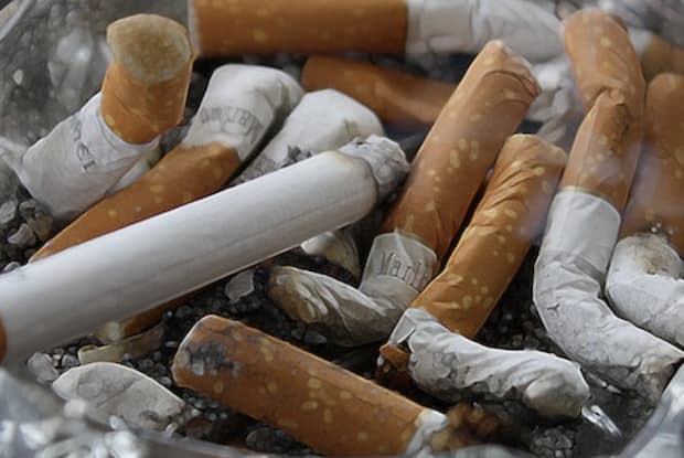 Many used cigarettes in an ashtray