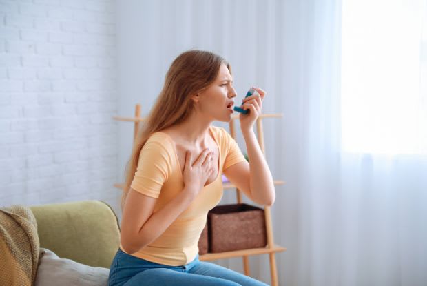 a woman using an inhaler