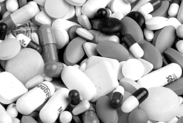 a black and white image of numerous different medication tablets