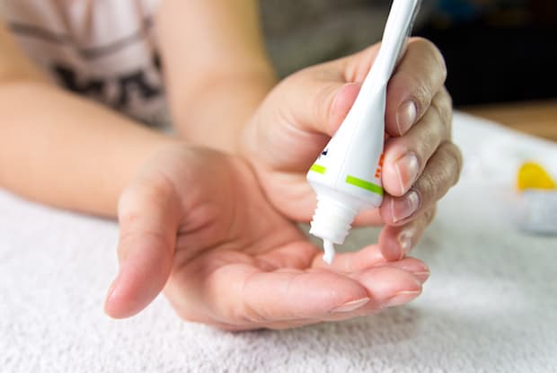 a person putting lotion on their hand