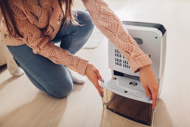 a dehumidifier being emptied