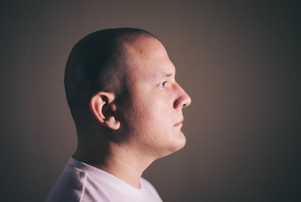 the profile of a bald man