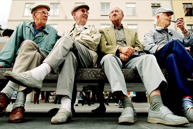 four men sitting on a bench