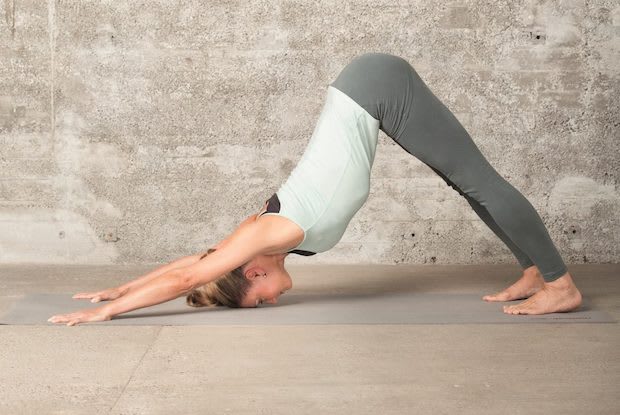 a woman doing the downward-dog yoga pose