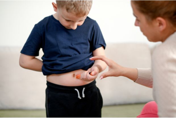 a mom teaching her diabetic child how to inject insulin