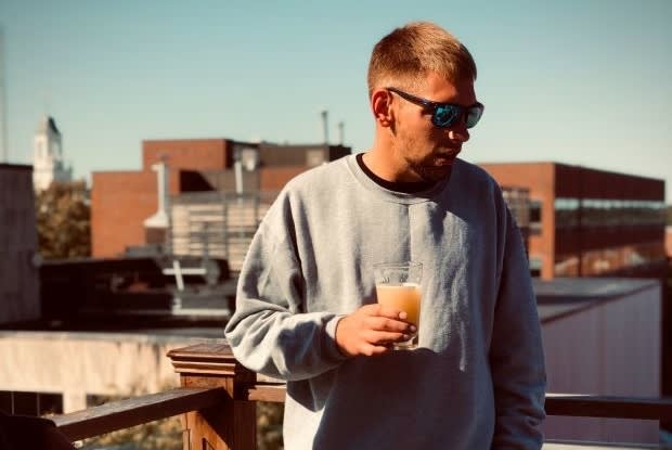 a man holding a cloudy beverage