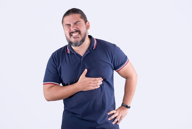 a man clutching his chest in pain