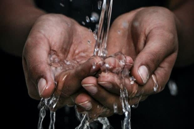 water running over hands