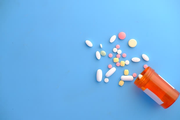 a pill bottle with scattered pills