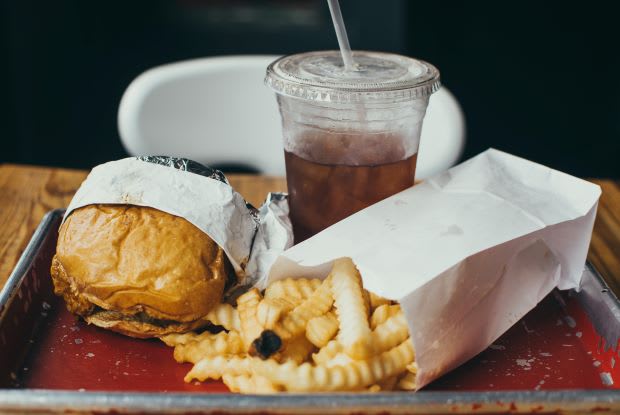 burgers and fries on a metal plate