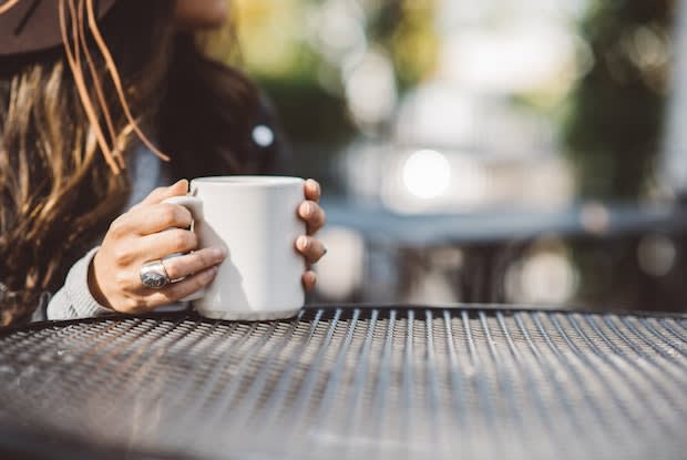 someone holding a cup of coffee