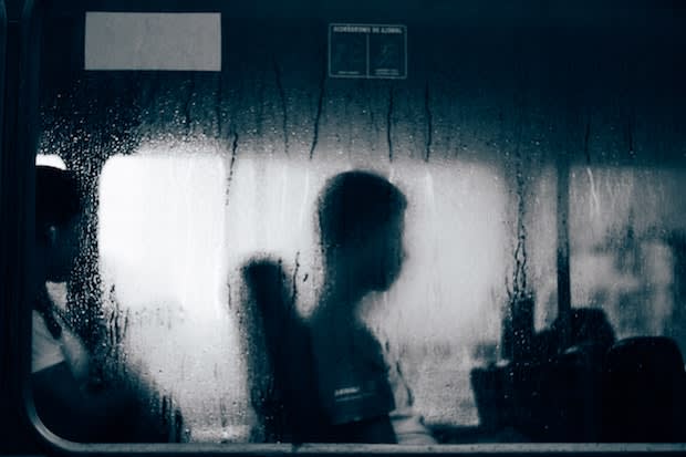 a person sitting in a bus with a fogged up window