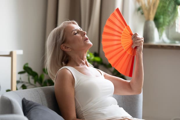 woman using a hand-held fan