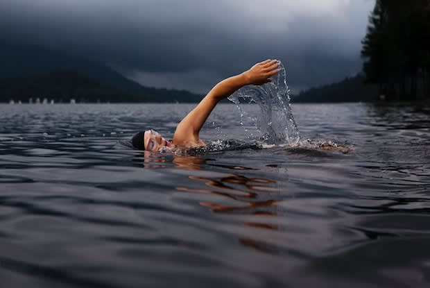 a person swimming in the lake