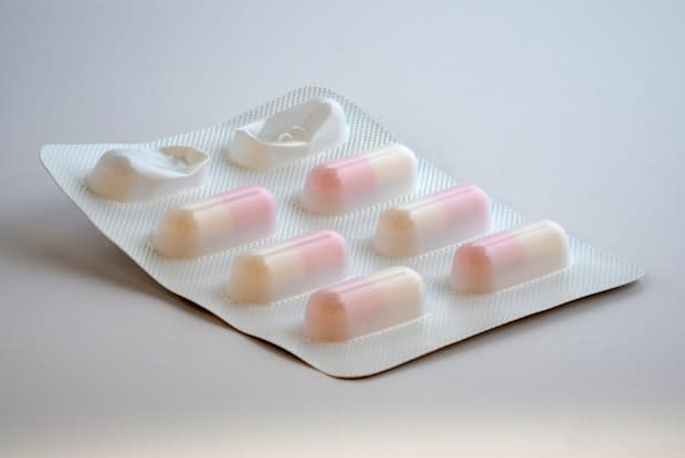 a pack of pink and white pills