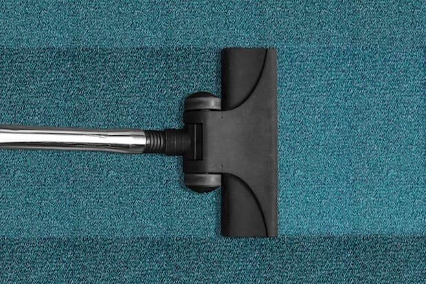 A vacuum cleaner cleaning a carpet