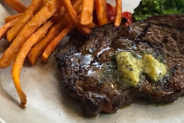 a plate of steak and fries