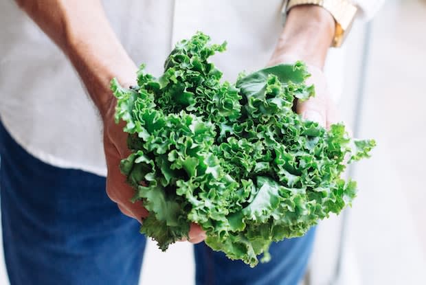 a woman holding kale