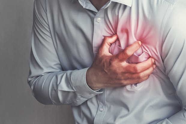 a man clutching his chest in pain