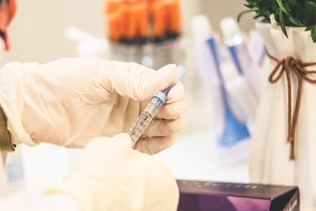 a doctor holding an insulin needle