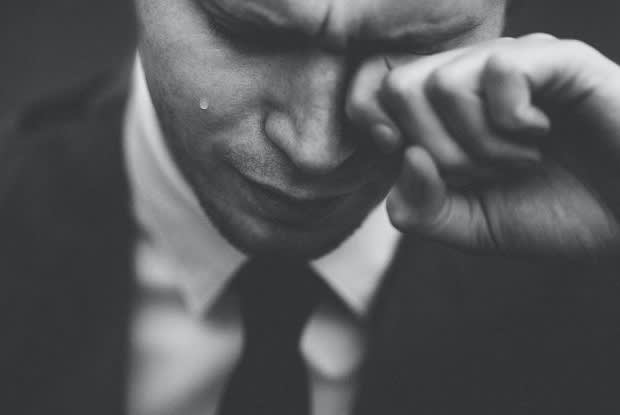a black-and-white photo of a man crying