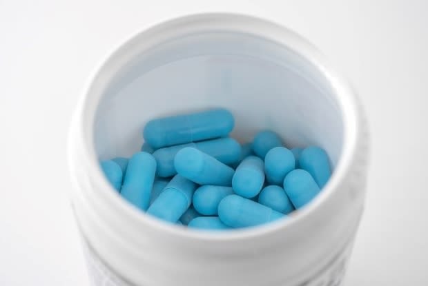 blue pills in a white container