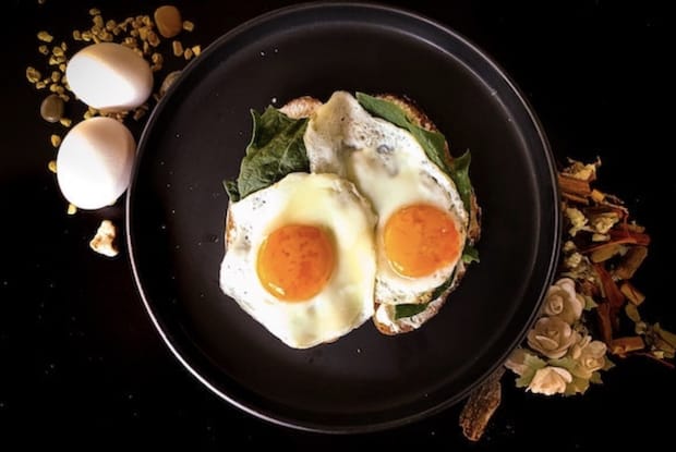 toast topped with spinach greens and eggs