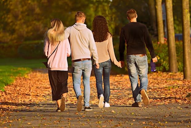 four people walking together